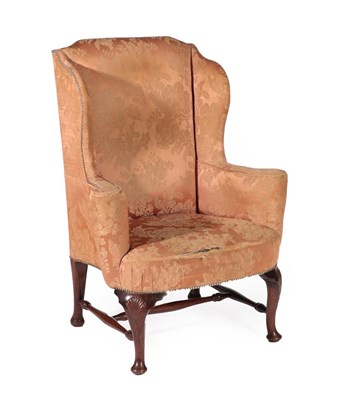 Lot 720 - A George III Style Wing-Back Armchair, probably early 19th century, covered in close-nailed...