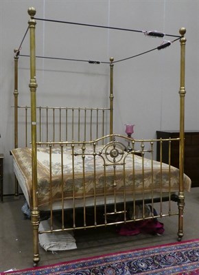 Lot 733 - A Victorian Super Kingsize Brass Four-Poster Bed, circa 1880, the tubular frame with ball...