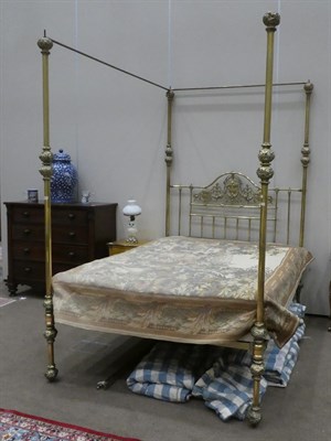 Lot 734 - A Victorian Kingsize Brass Four-Poster Bed, circa 1880, the tubular frame with hollow bulbous...