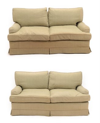 Lot 735 - A Pair of Feather-Filled Three-Seater Sofas, modern, with green patten loose covers, with...