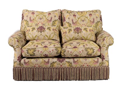 Lot 741 - ~ A Two-Seater Feather-Filled Sofa, modern, covered in floral green fabric decorated with...