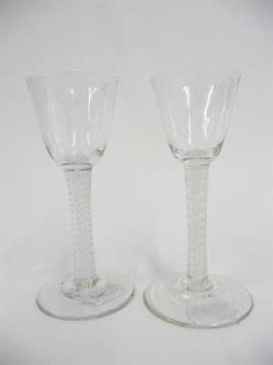 Lot 26 - A Near Pair of Wine Glasses, circa 1760, the rounded funnel bowls on double series opaque twist...