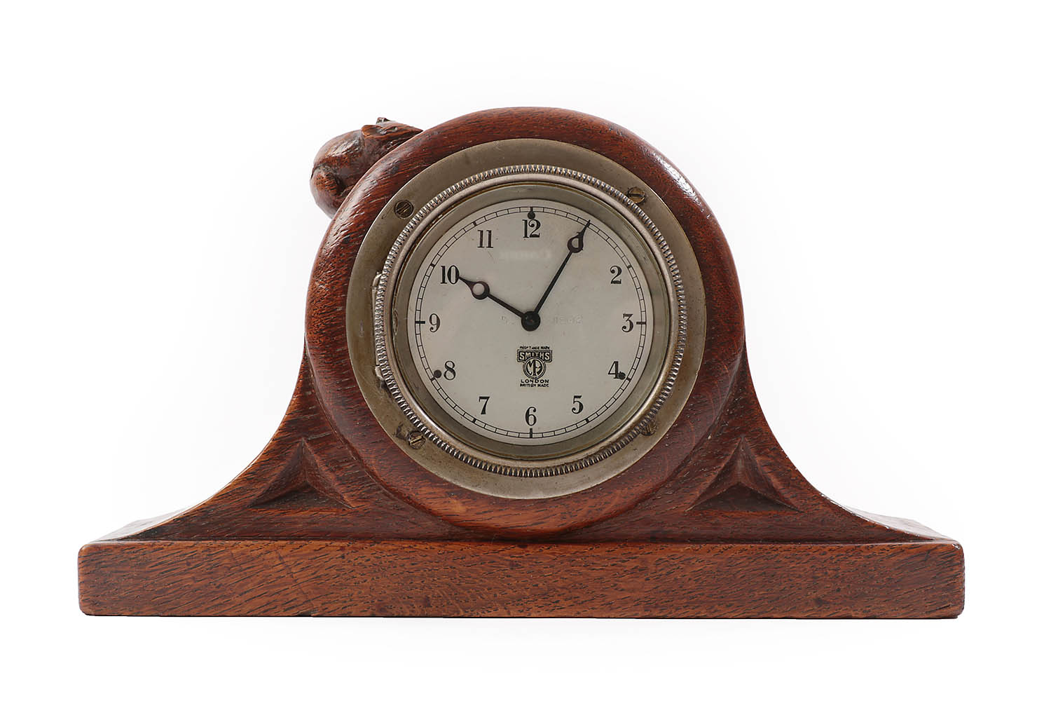 Lot 2084 - Robert Mouseman Thompson (1876-1955): An English Oak Mantel Clock, the case with triangular...