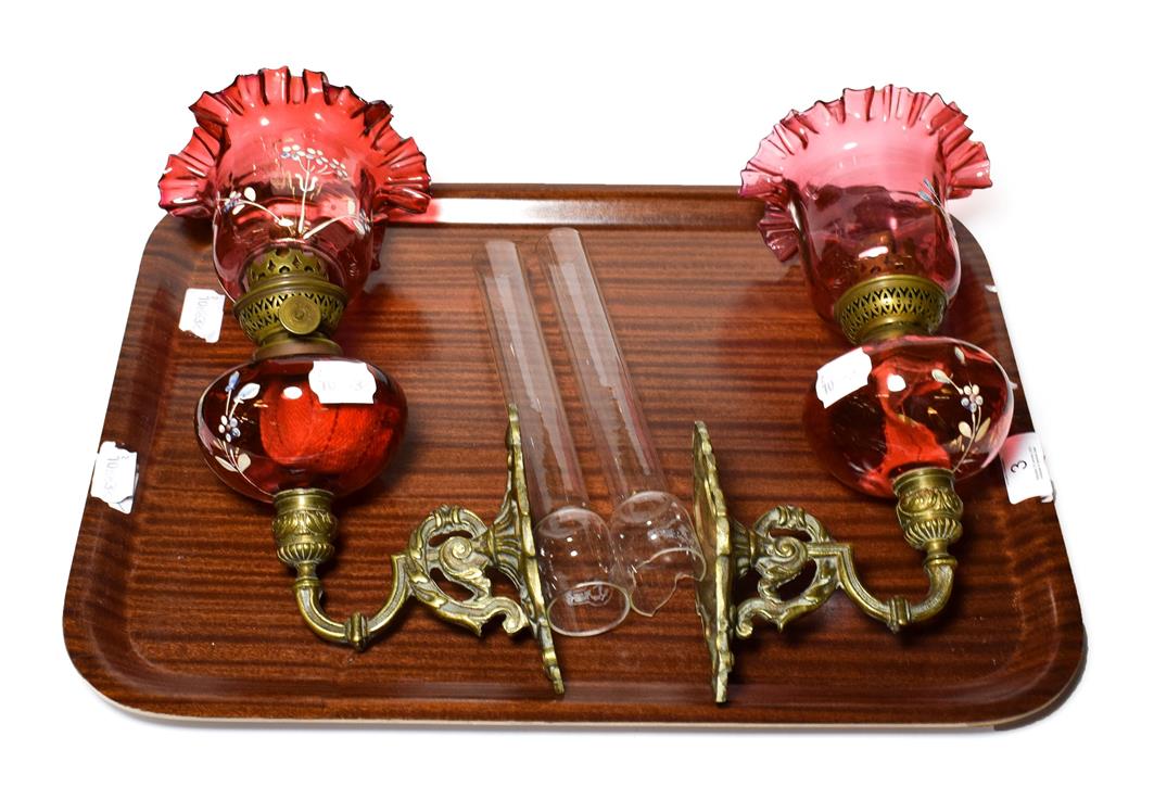 Lot 3 - A pair of Victorian cranberry glass oil lamps
