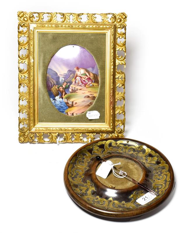 Lot 21 - A Victorian circular brass inkstand dish, with pen and a Continental porcelain plaque depicting...