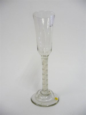 Lot 35 - An Ale Glass, circa 1765, the plain round funnel bowl on double series opaque twist stem comprising
