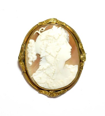 Lot 76 - A shell cameo depicting a maiden in a yellow metal frame, measures 6.4cm by 5.5cm