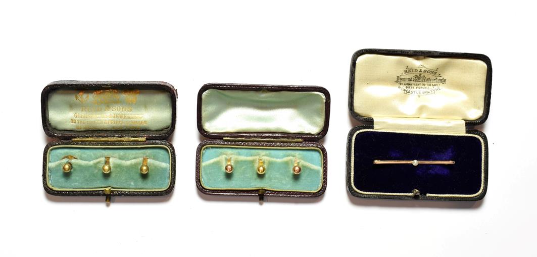 Lot 84 - A set of three dress studs, two hallmarked for 9 carat gold and one stamped '18CT', cased; a set of