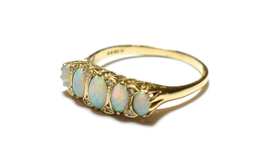 Lot 94 - A 9 carat gold opal ring, the five graduated oval opals with eight cut diamond accents, to a...