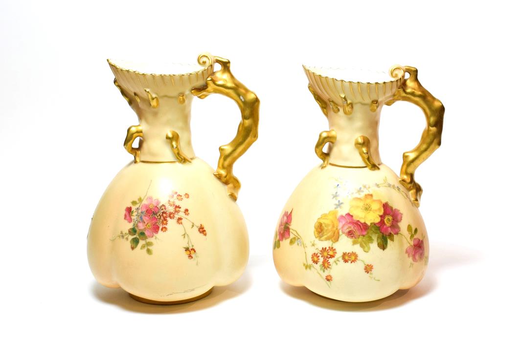 Lot 97 - A pair of Royal Worcester blush ivory ewers, 16.25cm.