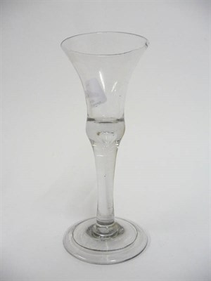 Lot 44 - A Wine Glass, circa 1740, the thistle bowl with basal air tear on plain stem and folded...