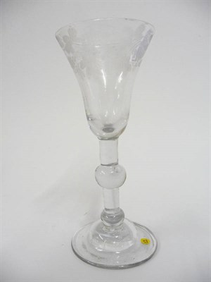 Lot 50 - A Baluster Wine Glass, circa 1725, the bell bowl engraved with fruiting vine, on a double...