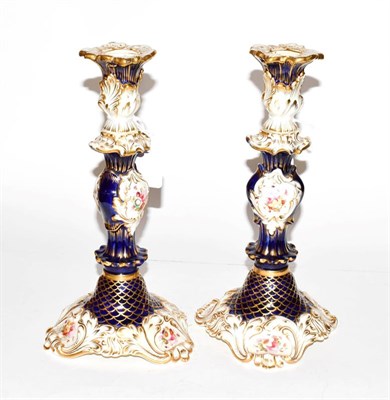 Lot 209 - A pair of 19th century English porcelain cobalt blue floral and gilt decorated candlesticks,...