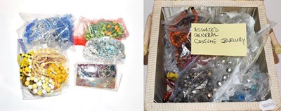 Lot 217 - Two boxes of costume jewellery including beaded necklaces, hair slides, bangles etc