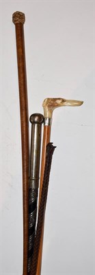 Lot 241 - Three riding crops, one depicting a dogs head with a mounted silver collar