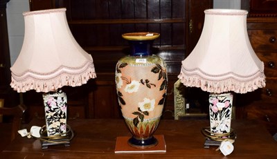 Lot 263 - A Royal Doulton stoneware floral decorated vase, 44.5cm high, together with a pair of floral...
