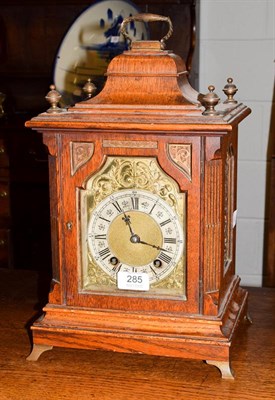 Lot 285 - An oak quarter striking mantel clock