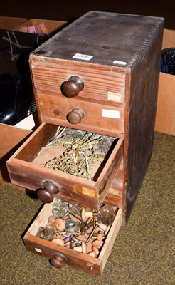 Lot 306 - A six drawer wooden cabinet containing a clock makers parts, including clock keys, clock hands,...