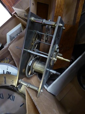 Lot 314 - A burr walnut veneered drop dial wall clock, two single fusee movements, a quantity of clock...