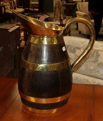 Lot 338 - A wood and brass ewer