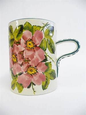 Lot 77 - A Robert Heron "Wemyss Ware" Mug, painted with pink wild roses within bottle green lined...