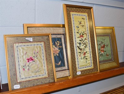 Lot 1035 - Four Oriental embroidered silk panels (framed)