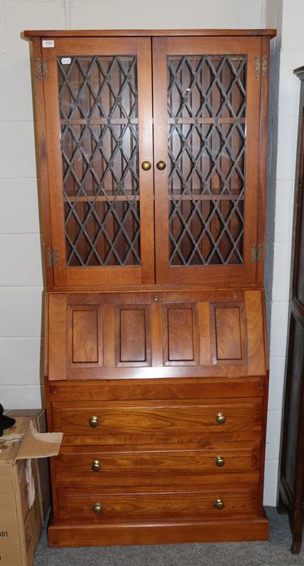 Lot 1065 - A modern oak bureau bookcase with leaded glass upper section, 84cm by 28cm by 185cm