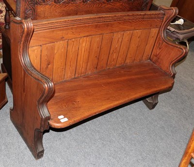 Lot 1075 - A small pitch pine church pew, 114cm by 40cm by 85cm