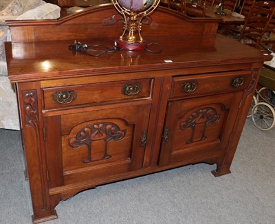 Lot 1078 - An Arts & Crafts oak sideboard, carved with stylised flower and brass handles, 152cm by 54cm by...