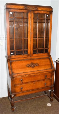 Lot 1088 - A 1920s oak bureau bookcase, 90cm by 44cm by 194cm