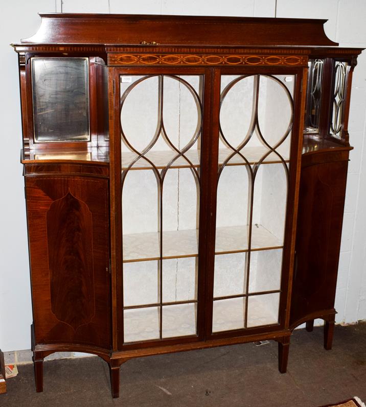 Lot 1090 - An Edwardian inlaid mahogany display cabinet, the two glazed doors flanked by mirrored recesses...