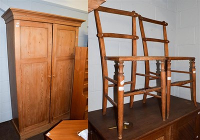 Lot 1097 - A pine double wardrobe, together with two cane seated bedroom chairs. Wardrobe 204.5cm by 134cm...