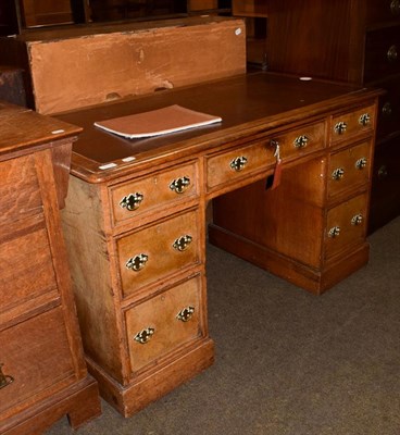 Lot 1113 - A leather inset oak pedestal desk, with burr walnut drawer fronts, bearing paper label John...