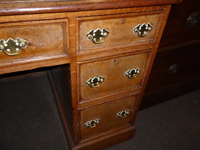 Lot 1113 - A leather inset oak pedestal desk, with burr walnut drawer fronts, bearing paper label John...