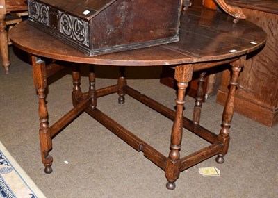 Lot 1115 - An early 19th century oak gateleg dining table, 148cm by 123cm by 73cm high