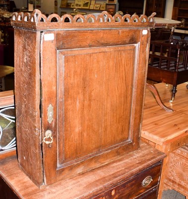 Lot 1118 - An 18th century panelled oak hanging wall cupboard, 63cm by 23cm by 73cm