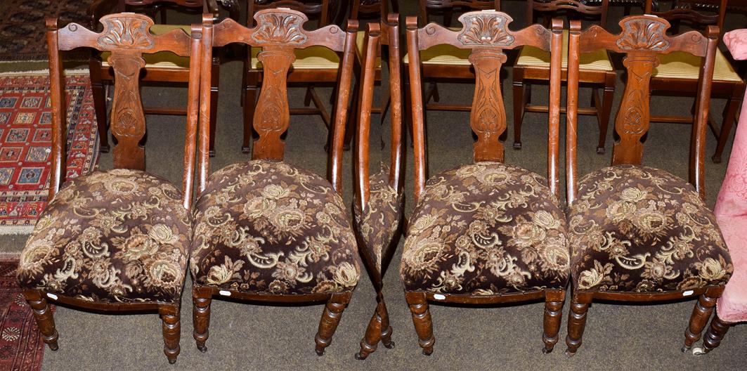 Lot 1149 - A set of four Victorian carved walnut dining chairs with over-stuffed seats