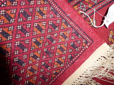 Lot 1160 - Lahore Bukhara rug, the blood red field of Salor güls enclosed by multiple borders, 186cm by...