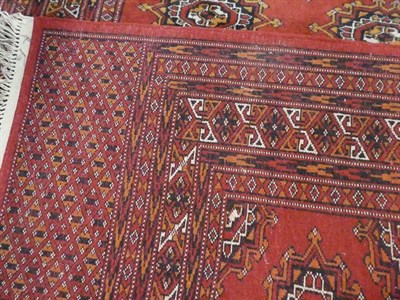 Lot 1160 - Lahore Bukhara rug, the blood red field of Salor güls enclosed by multiple borders, 186cm by...