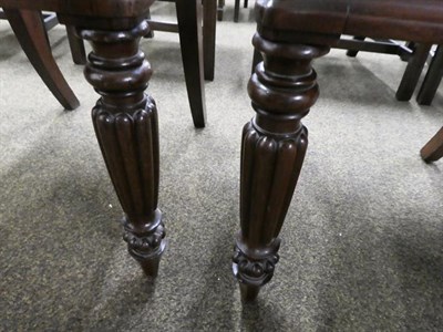 Lot 1165 - A set of four early 19th century mahogany dining chairs on reeded legs