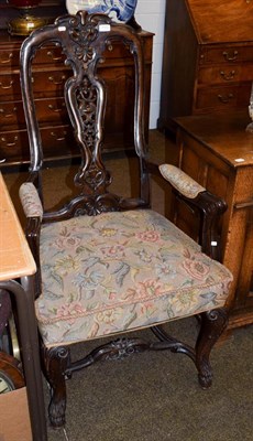 Lot 1172 - A carved walnut armchair in the 17th century style, with carved hoof feet joined by a...