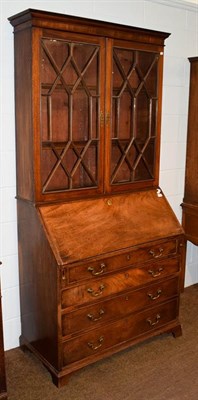 Lot 1174 - A George III mahogany bureau bookcase, the upper section with glazed astragal doors enclosing...