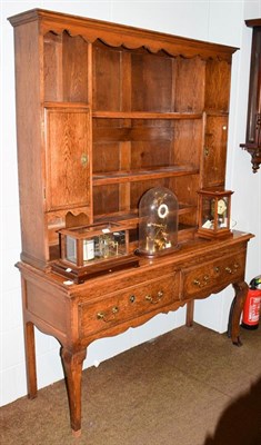 Lot 1175 - A 19th century oak dresser and rack, the upper section with scroll carved apron, the base...