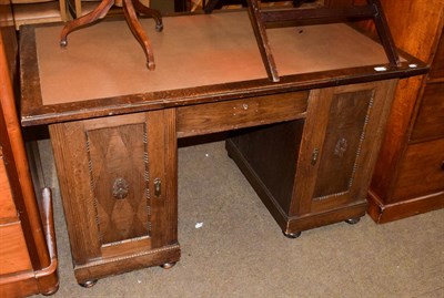 Lot 1183 - An early 20th century oak pedestal desk with leather insert, 141cm by 80cm by 79cm