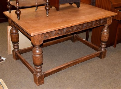 Lot 1199 - A carved oak refectory table with turned bulbous legs joined stretchers, 137cm by 90cm by 75cm