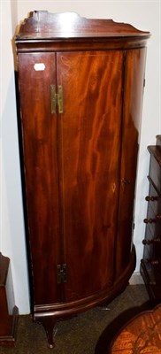 Lot 1213 - A mahogany free standing bow fronted corner cabinet, 70cm by 48cm by 138cm