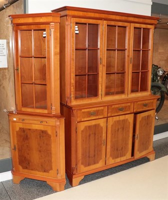 Lot 1222 - A yew wood veneered glazed bookcase, and a yew wood veneered glazed floorstanding corner...