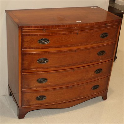 Lot 1225 - A George III style bow fronted yew wood veneered four height chest of drawers with brush slide,...