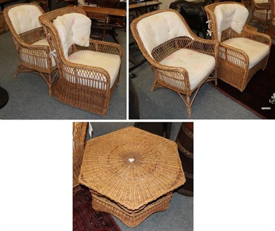 Lot 1236 - Four wicker armchairs and a wicker hexagonal shaped coffee table (5)