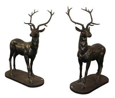 Lot 1237 - A large pair of patinated metal models of stags, each 103cm by 148cm